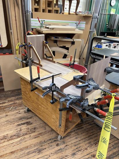 Two opposite corners of the cabinet are being glued together.