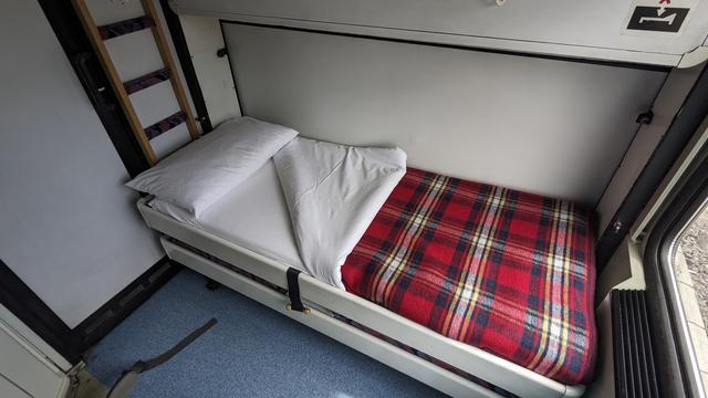 A comfortable bed in a night train, prepared like in a hotel.