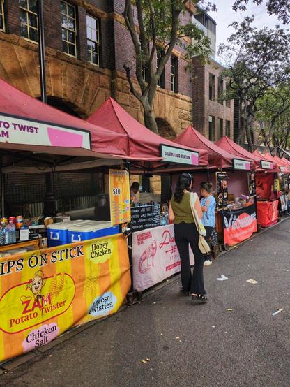 Food stalls at The Rocks market. The second stall in this photo offers kangaroo, emu, crocodile, and Moroccan lamb.