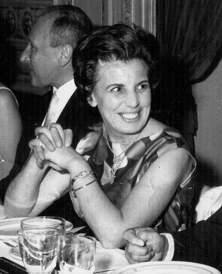 Beatriz Ghirelli sitting at a formal dinner table smiling