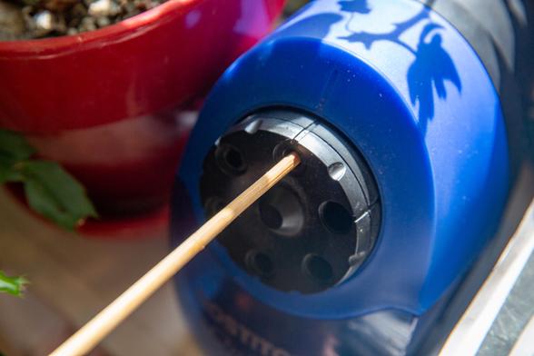 Bamboo skewer inserted into an electric pencil sharpener.