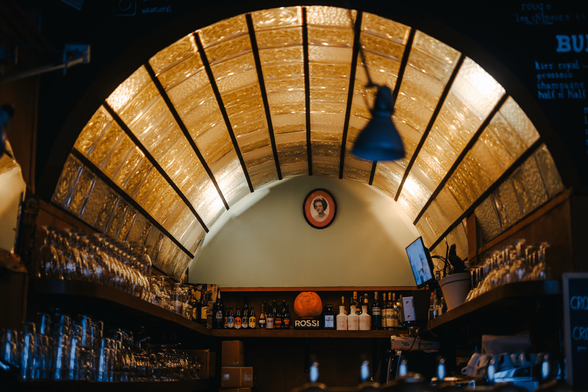 A view on the backlit, translucent, vaulted ceiling behind the bar of Kastar