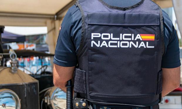 Parte trasera de un agente de la policía nacional donde se puede ver el nombre del cuerpo. (Getty Images)