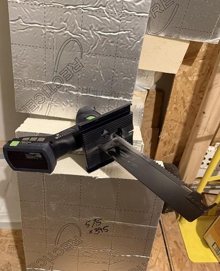 Photo of a Festool ISC 240 Insulation saw sitting atop some freshly cut 120mm PIR insulation.