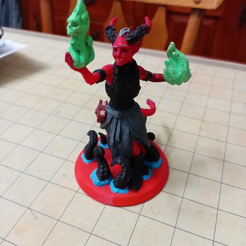 6 inch 3D printed mini figure of a tiefling surrounded by black tentacles and green flames in their hands