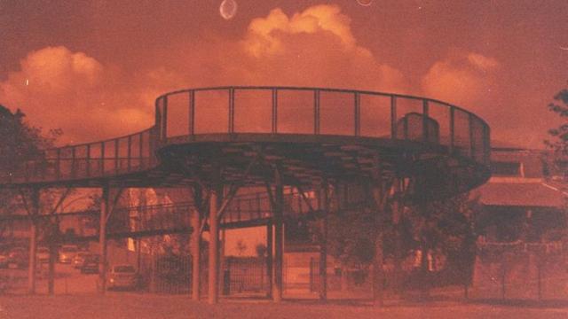 A redscaled view of the metal footbridge in the Parque Infante Dom Pedro in Aveiro.