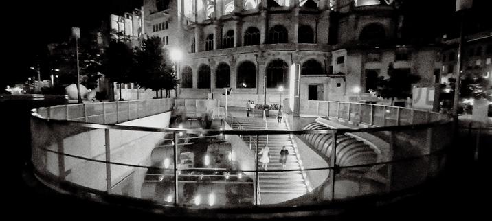 exit of "les halles" in paris, in front of a church, black and white, at night