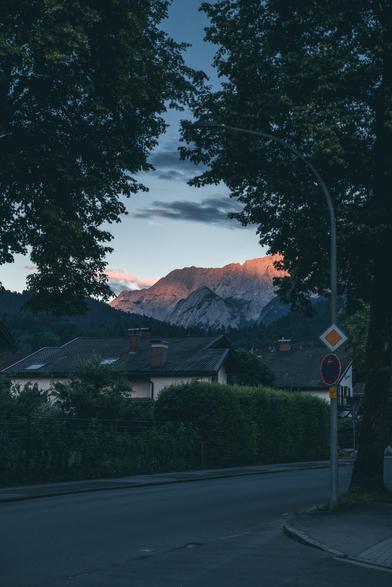 Sunset over the mountains seen from the sidewalk in Garmisch.