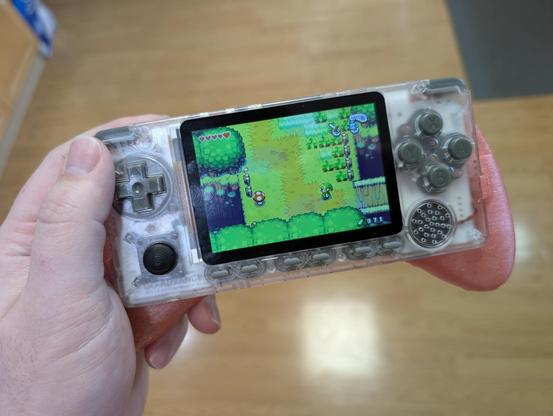 Front view of the controller grip with the ODROID-GO Advance installed. I'm holding it in my left hand, similar to how I would hold when playing. The Legend of Zelda: The Minish Cap is on screen.