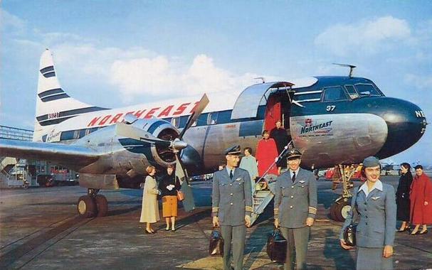 While passengers alight, the crew pose with the plane.
