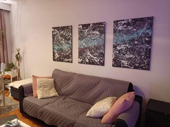 Weird art on the wall. Sofa under it.