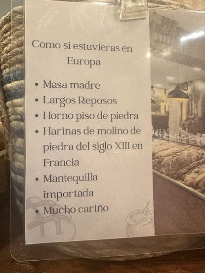 A sign detailing ingredients and methods for baking, emphasizing traditional European techniques. Key points include: sourdough starter, long resting periods, stone oven, 13th-century stone mill flour from France, imported butter, and a note of care in preparation