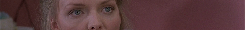 Michelle Pfeiffer looking shocked as she realizes she's in Amazon Women on the Moon.