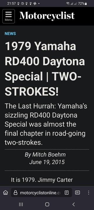 The image shows a screenshot of a mobile device displaying a news article from the "Motorcyclist" website. The article is titled "1979 Yamaha RD400 Daytona Special | TWO-STROKES!" and is written by Mitch Boehm, dated June 19, 2015. The article discusses the Yamaha RD400 Daytona Special, highlighting it as a significant model in the history of road-going two-stroke motorcycles. The background of the article is black, with white and blue text. The top of the screen shows the time as 21:57, the battery level at 102%, and the carrier signal strength. The website's URL, "motorcyclistonline.com," is visible at the bottom of the screen.

 Ovis2-8B

🌱 Energy used: 0.212 Wh