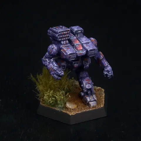 A painted miniature of a Howler 'Mech.  It is painted in a predominantly purple camo pattern with dots of lighter purple and rust red.  The cockpit glass is pink.  The miniature is based to look like it is stepping through heavy brush.