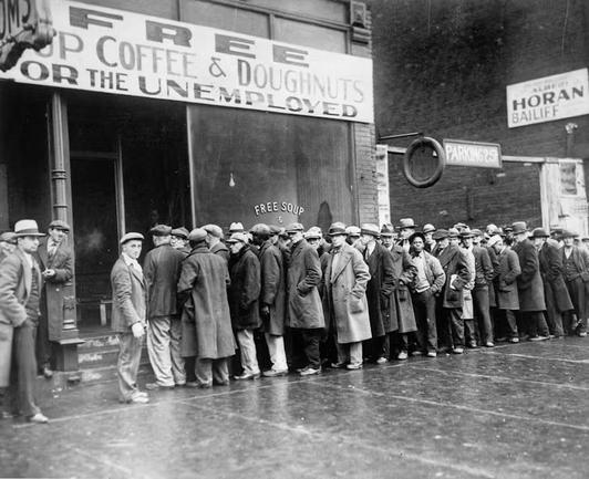 A crowd of men wait for free coffee and doughnuts during the Great Depression