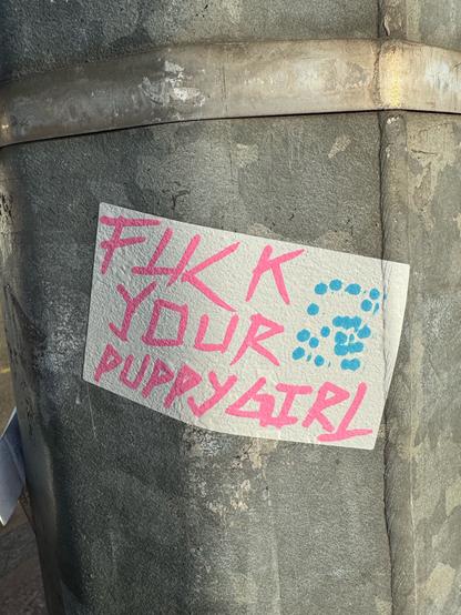 Another hand-written sticker tag that says “fuck your puppy girl”