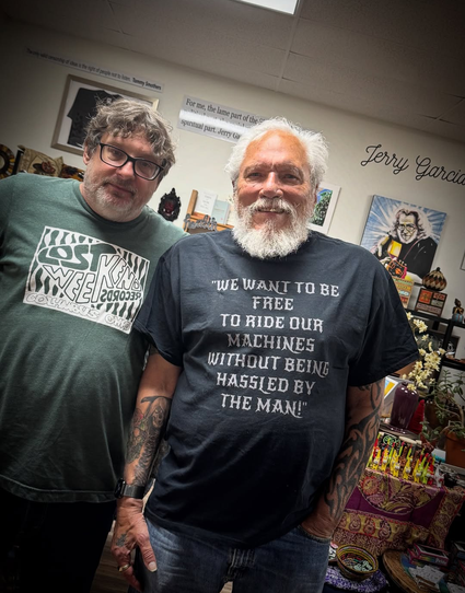 Jorma wearing shirt that reads WE WANT TO BE FREE TO RIDE OUR MACHINES WITHOUT BEING HASSLES BY THE MAN!