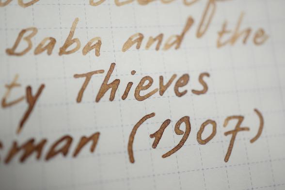 "(Ali) Baba and the (for)ty Thieves, (Hous)man (1907)" written in light-to-dark-brown ink