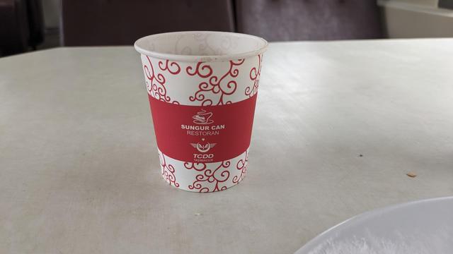 Closeup of a paper cup of TCDD in a dining car.