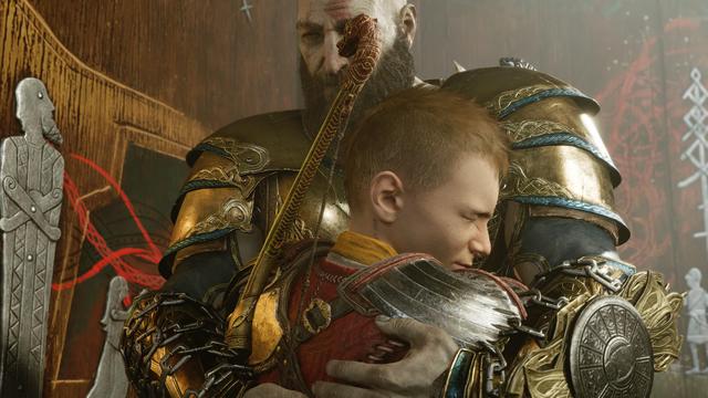 Kratos, a huge, bearded, bald-headed guy clad in metal armour and wearing chains around his armguards, is hugging his much smaller teenage son Atreus, who is wearing metal and leather armour and a bow. They are visibly relieved to be reunited.