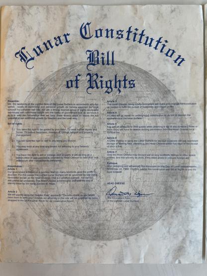 A document titled "Lunar Constitution Bill of Rights" features a preamble and a series of articles outlining rights and governance on the lunar surface. It includes whimsical elements, such as references to "Head Cheese," and stipulations regarding property and management.