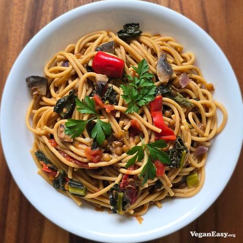 Photo of spaghetti with lentils, mushrooms, kale in a tomato sauce made in a pressure cooker.