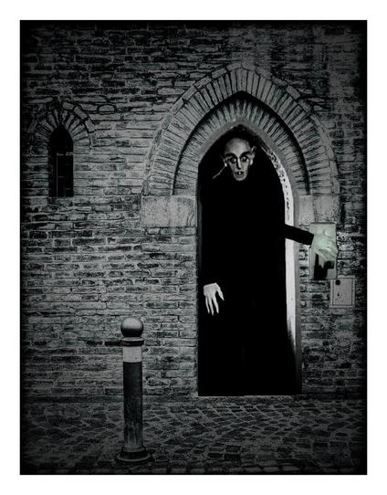 Nearly exactly the same scene as before but darker. This time his hand is lower down as he has flipped the light switch off.