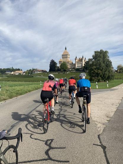 View of cyclists and the Chateau de Vufflens