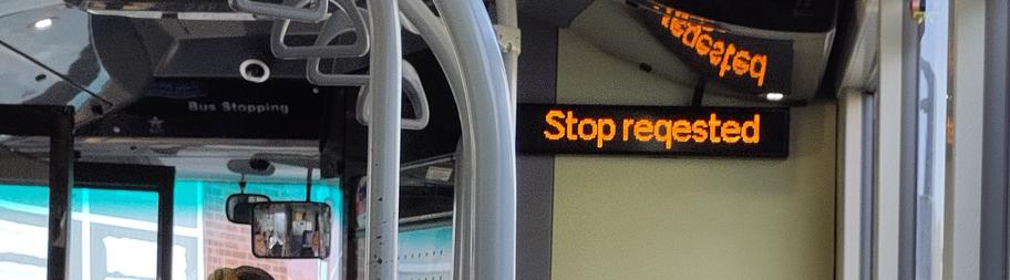 A sign on a bus, reading "Stop reqested"