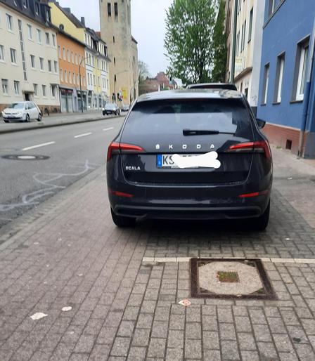 Bild zeigt KFZ, das zum Teil auf dem Radweg parkt.