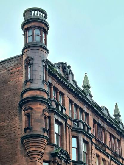 A narrow turret on the corner of a late Victorian commercial building in Glasgow.