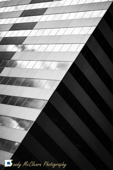 Corner of a building at 45 degrees splitting the illuminated side and the side in shadow.