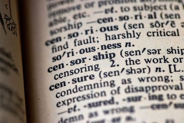 A photograph of a dictionary page which is open at the definition of censorship