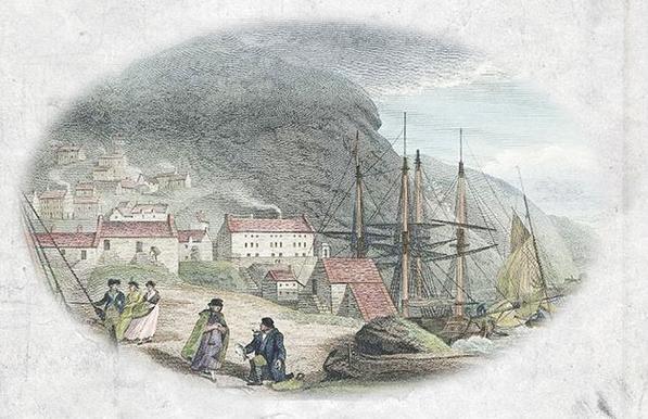 Early nineteenth-century view of Barmouth as seen from the beach towards the town huddled against the side of a steeply rising mountain. In the foreground a fisherman, a Welshwoman knitting a sock and three finely dressed women going for a walk between tied up boats.