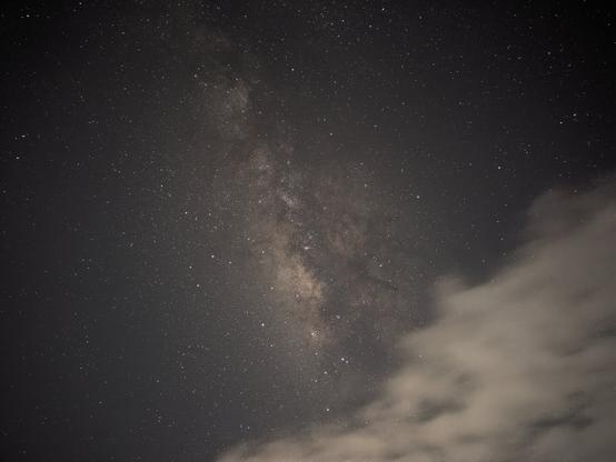 A milky way photo in landscape, with clouds being in the way.
