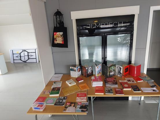 Two tables filled to the brim with working class literature, organized after communist principles, i.e. Everyone who can contributes books of their own to the table, and anyone who needs a book may take it