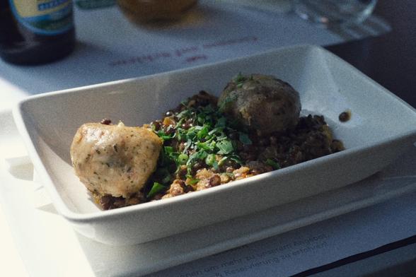 Lentils dish in the sunlight at the dining car's table.