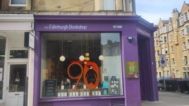 The finished Penguin 90 painted window and book display in the Edinburgh Bookshop, taken from further back to include the whole frontage of the bookshop