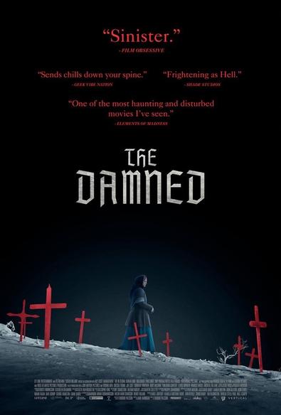 The poster for The Damned. A woman in a long blue dress is walking among a cemetery of red crosses.