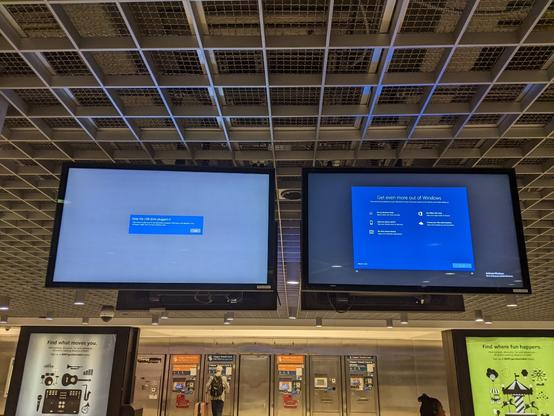 Bart signage at Powell Street station, getting windows reinstalled - with an error message on the screen