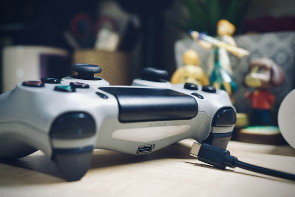 A Sony PlayStation 4 controller that has been modified with a USB type C port for charging and data transmission.