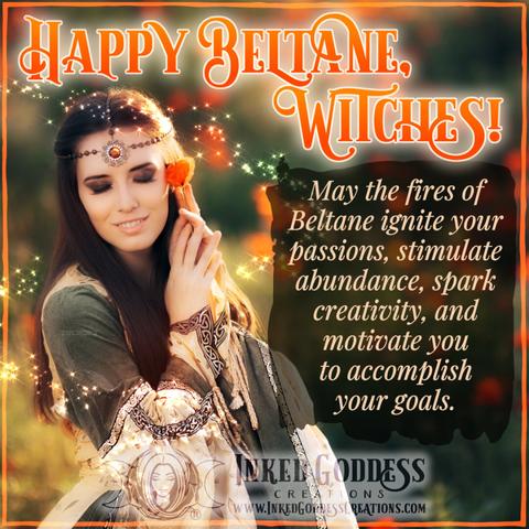 A young brunette woman is wearing a medieval-style dress and a beaded head chain with a large amber stone in the center. She is gently holding an orange poppy flower on a stem to her cheek with both hands. Her eyes are closed and she is surrounded by magick sparkles. The title on the image reads, "Happy Beltane, Witches!" and a blessing. Presented by Inked Goddess Creations.