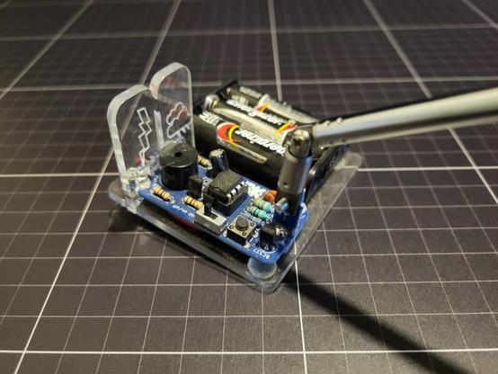 Small Blue PCB, with batteries and an Ariel, Acrylic display with a lightning bolt and a cloud.