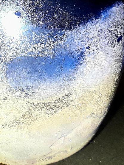 Ice condensing on a frozen blue glass tumbler, with ice frozen into the bottom, and filled with subzero Jägermeißter resembles an ice moon.