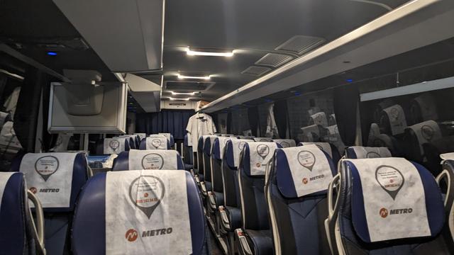 A modern travel bus with 2+2 seating arrangement.