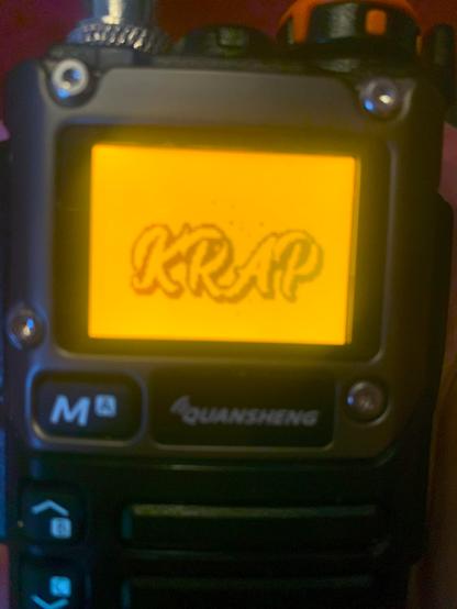 Radion, en Quansheng UV-K6, med "hackad" firmware, visar upp KRAP-logon när den startas.