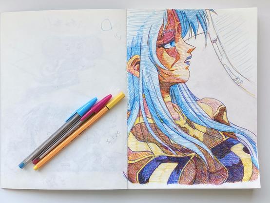 A photo of a page from a sketchbook.  It's filled with a side-profile portrait of an anime woman with light skin, long blue hair, and a sheer black and yellow top.  next to it are the cyan, magenta, and yellow pens used to color it.