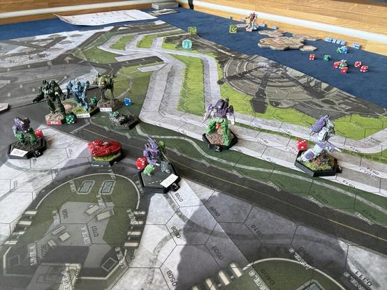 The purple mechs are fleeing the field, after they grabbed their objective cargos. A red hover craft is also part of their forces.