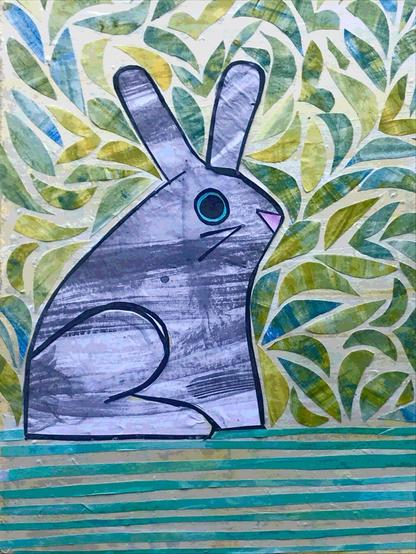 Simple gray rabbit on a green background of leaves and grass, all of which are made from cut paper painted by the artist-me!
